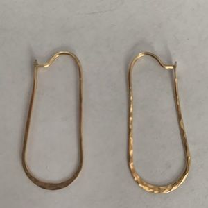 Hand-made thin gold earrings.